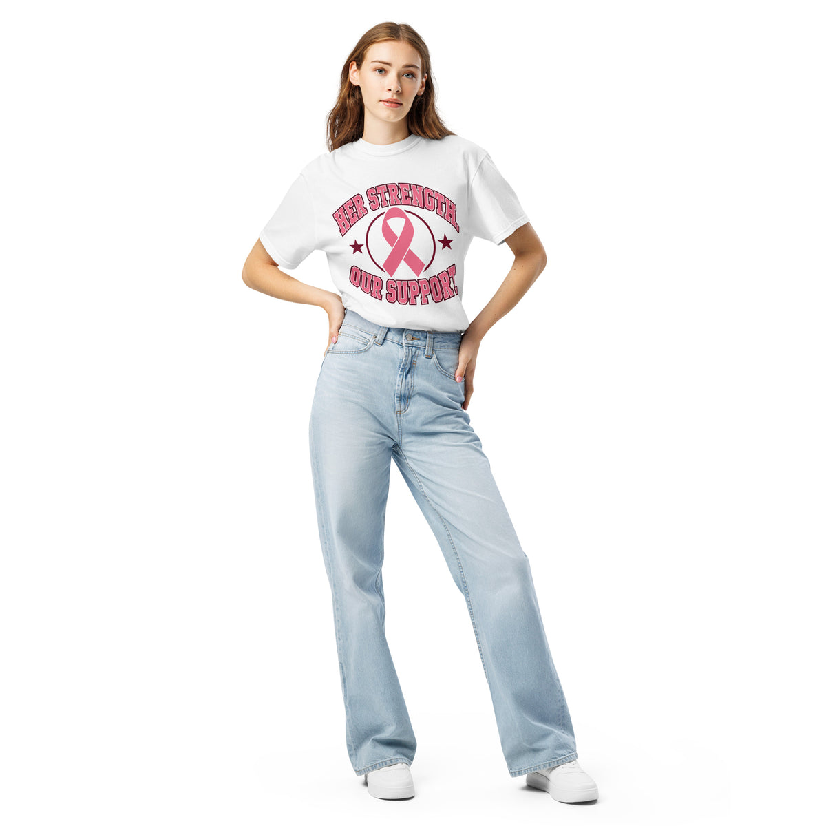 Full-length model wearing the white Her Strength tee with the pink ribbon design.