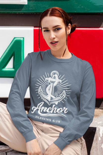 Person wearing a blue jean garment-dyed long sleeve tee with anchor design.