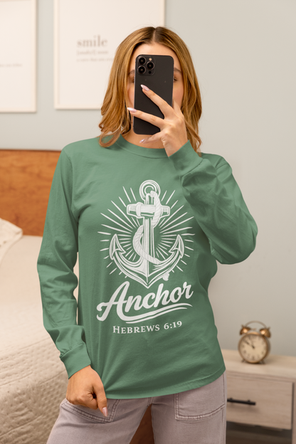 Person wearing a light green garment-dyed long sleeve tee with 'Anchor Hebrews 6:19' design.