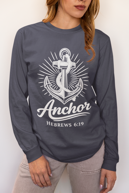 A woman wearing a navy long-sleeve t-shirt with a white anchor graphic and the text 'Anchor HEBREWS 6:19' printed on the front, paired with light gray jeans.