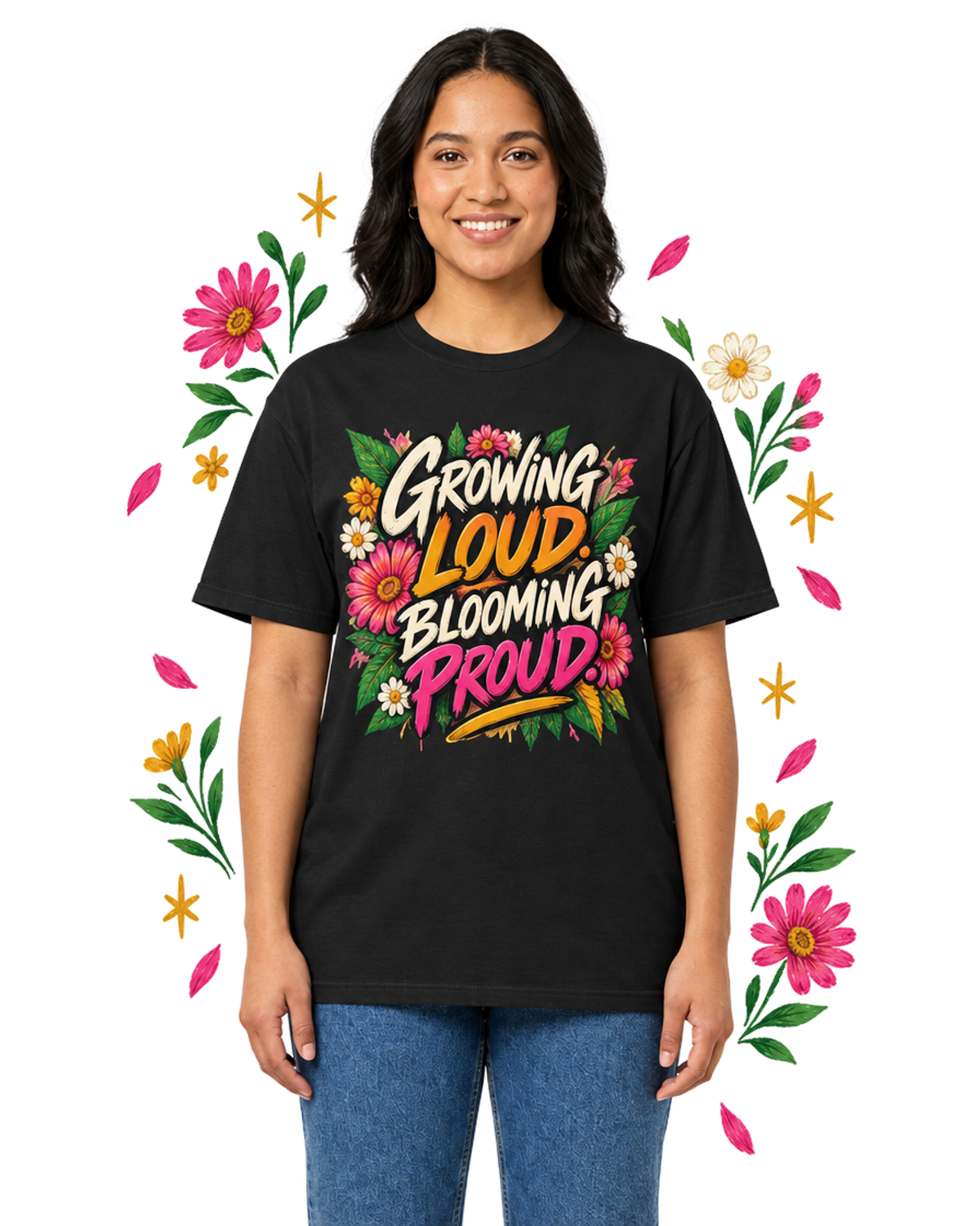 Female model wearing a black Growing Loud, Blooming Proud floral graphic tee with blue jeans, framed by pink, white, and yellow flowers.