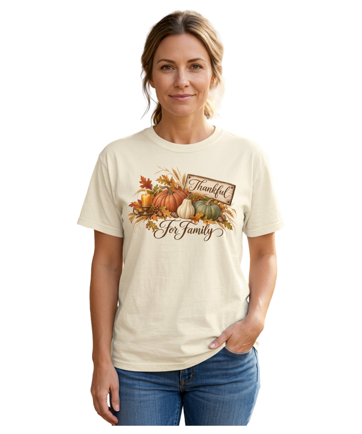Model wearing an ivory ‘Thankful Harvest for Family’ Comfort Colors tee featuring a rustic ‘Thankful’ sign, pumpkins, autumn leaves, wheat, a candle, and ‘For Family’ script.