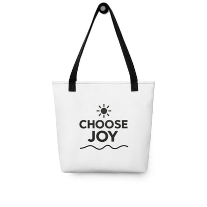 White Choose Joy tote bag with black handles, black lettering, a sun symbol, and a wavy underline.