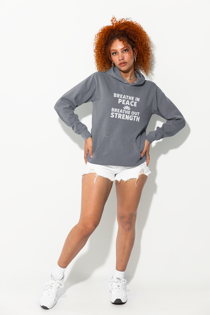 Woman wearing a denim hoodie with text, white shorts, and white sneakers on a white background
