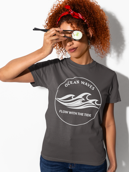 Person wearing a graphite 'Ocean Waves – Flow with the Tide' garment-dyed tee, face partially hidden.