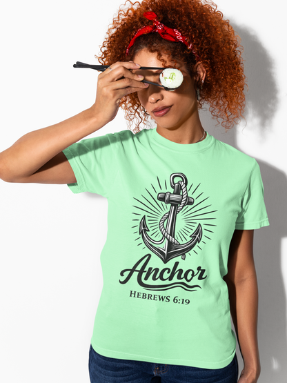 Person wearing an island reef (light green) t-shirt with an anchor design and text, holding sunglasses.