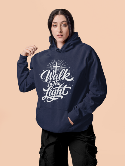 Person wearing a true navy blue hoodie with 'Walk In The Light' text on a beige background