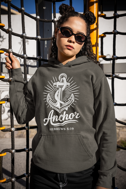 Person wearing a hoodie with an anchor design and text, standing on playground equipment.