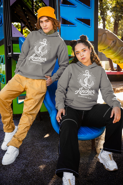 Two people wearing grey hoodies with an anchor design and 'Anchor Hebrews 6:19' text, posing outdoors.