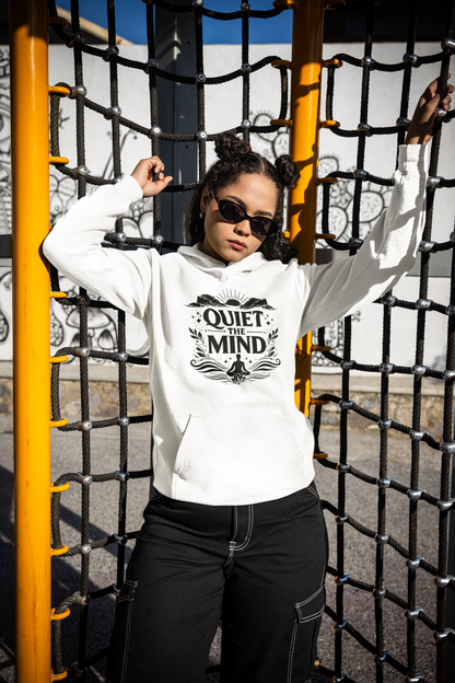 Person wearing a white hoodie with 'Quiet the Mind' text, standing in front of playground equipment.
