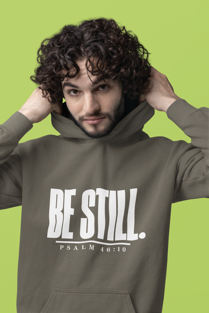 Person wearing a pepper grey hoodie with 'Be Still. Psalm 46:10' text.