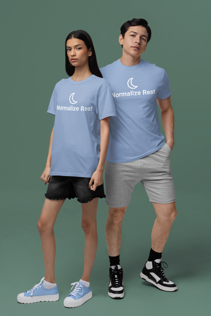 Two people wearing blue t-shirts with 'Normalize Rest' text on a green background