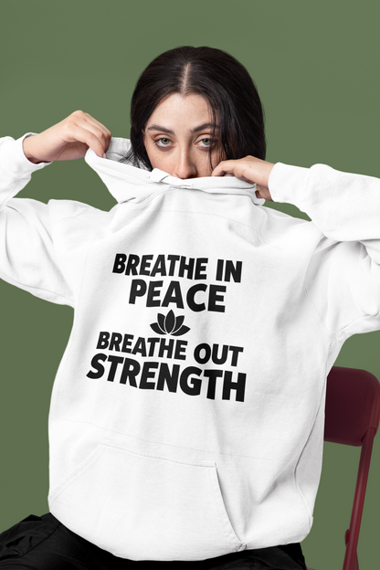 Person wearing a white hoodie with motivational text on a green background