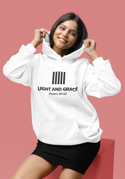 Woman wearing a white hoodie with text on a pink background
