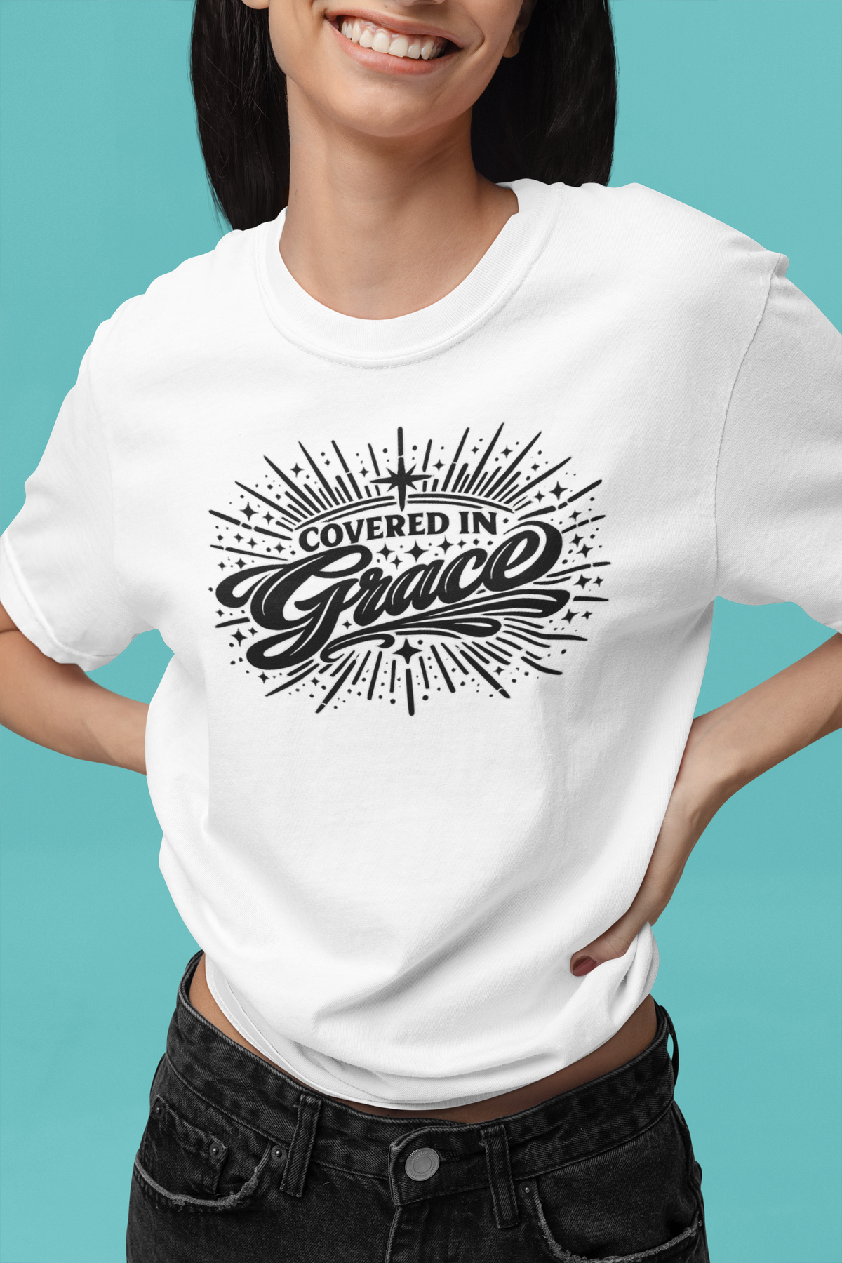 Person wearing a white t-shirt with 'Covered in Grace' design on a teal background