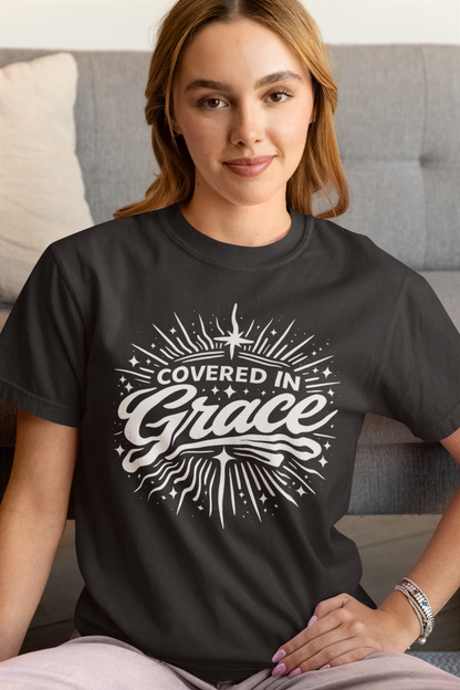 Woman wearing a black t-shirt with 'Covered in Grace' design.