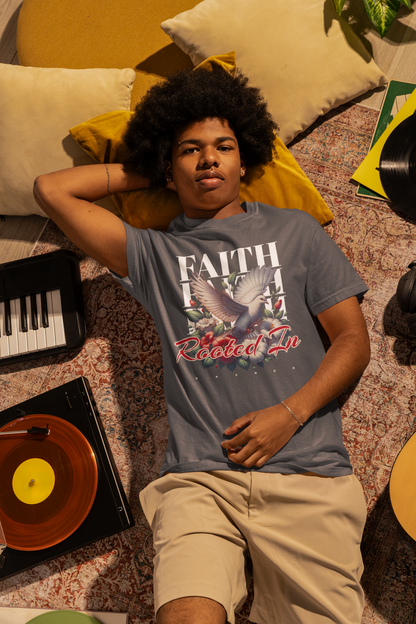 Person wearing a denim 'Rooted In Faith' garment-dyed tee featuring a dove and floral graphic.