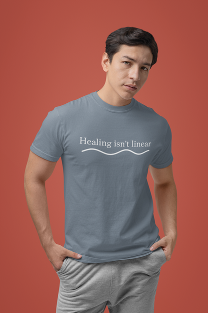 Person wearing a gray t-shirt with 'Healing isn't linear' text on a red background