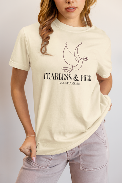Person wearing a beige t-shirt with 'Fearless & Free' text and dove graphic.
