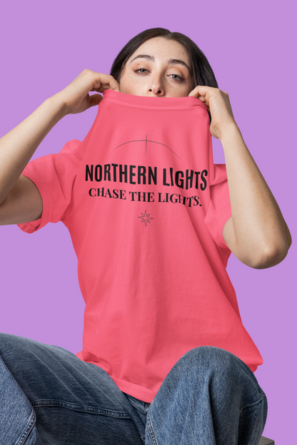Person wearing a crunchberry t-shirt with 'Northern Lights Chase the Lights' text on a purple background