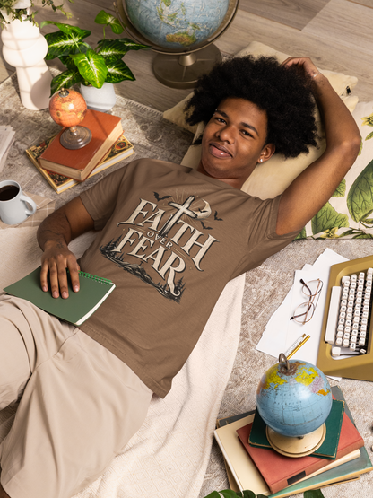 A person wearing an espresso brown Faith Over Fear garment-dyed graphic tee with a cross and Halloween-inspired design, in a lifestyle setting.