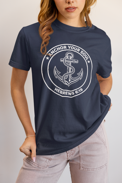 Person wearing a navy blue t-shirt with an anchor design and text.