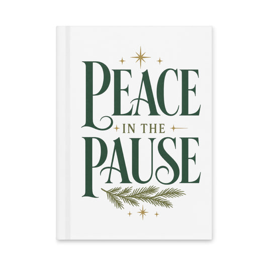 Front view of a white Peace in the Pause matte hardcover journal featuring forest-green lettering, gold stars, and an evergreen sprig.