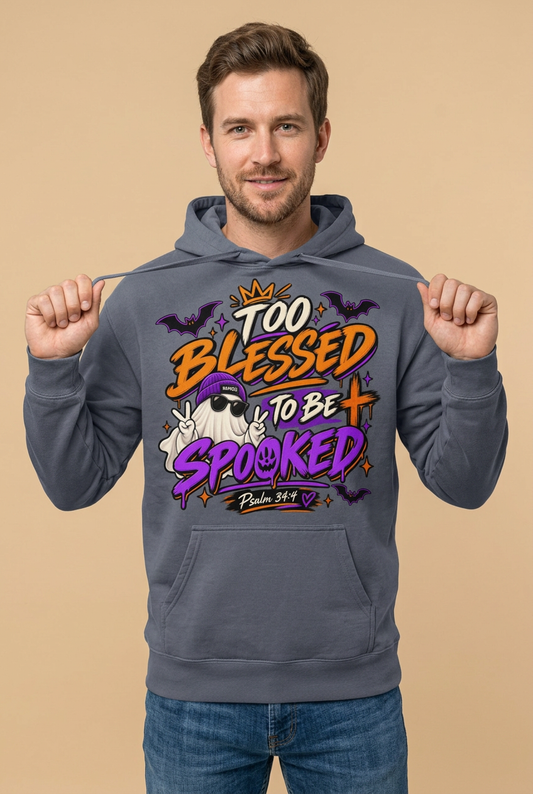 Male model holding drawstrings away from a Denim hoodie’s orange and purple ‘Too Blessed to Be Spooked’ design with a ghost, bats, cross, and Psalm 34:4.