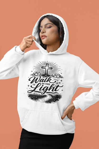 Person wearing a white hoodie with 'Walk in the Light' text and cross design on a peach background
