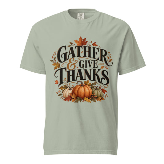 Bay green Comfort Colors tee with "Gather & Give Thanks" lettering, three pumpkins, and autumn leaves on the front.