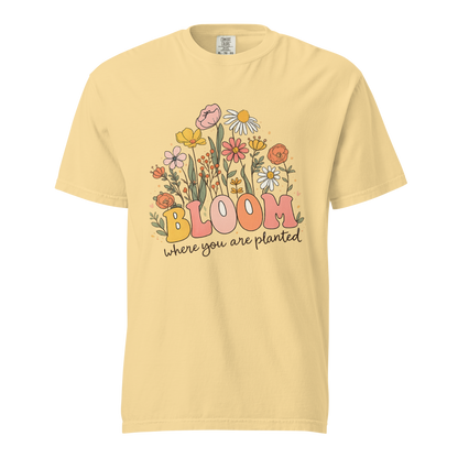 Flat mockup of a yellow 'Bloom Where You Are Planted' garment-dyed tee with wildflower garden graphic.