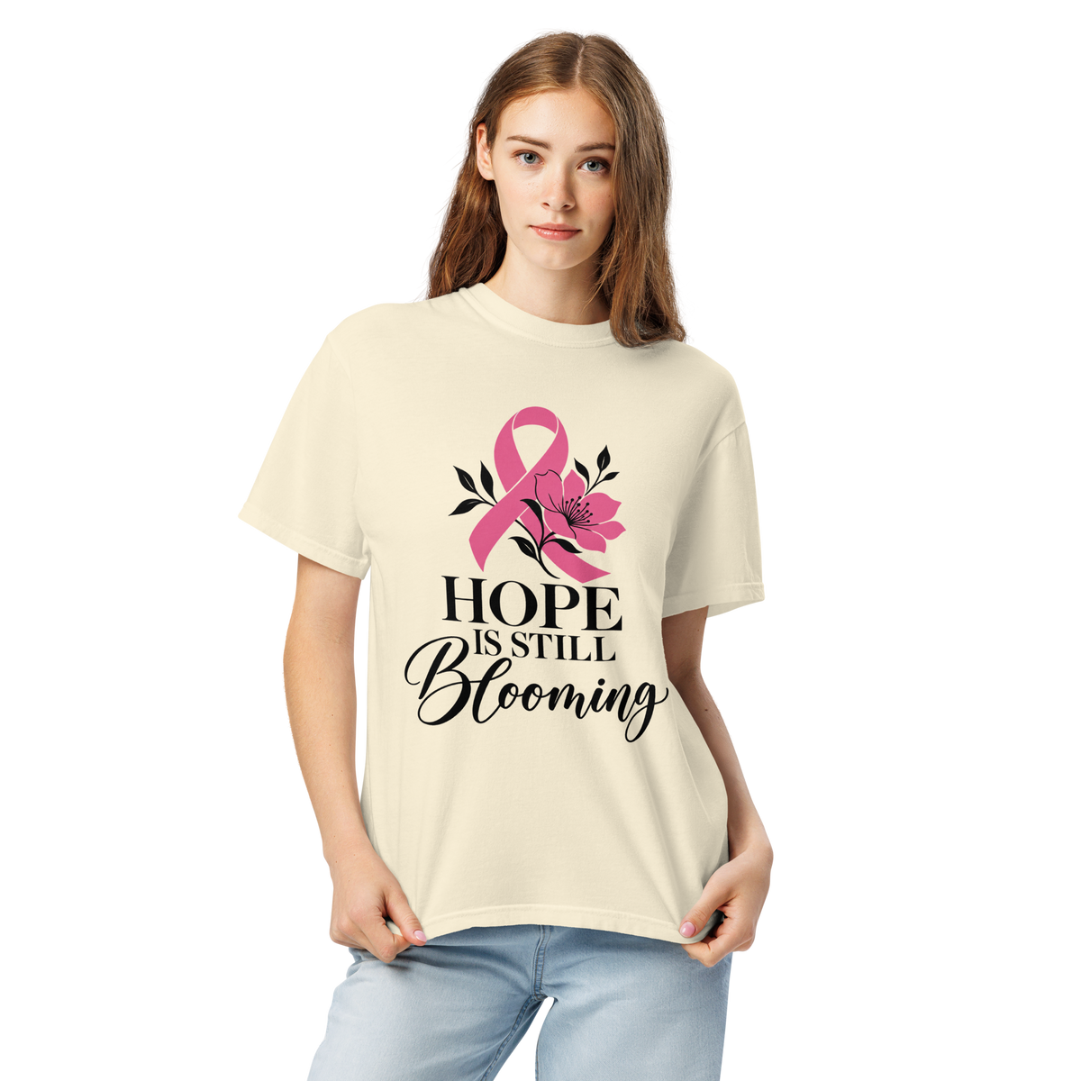 Standing model wearing the ivory “Hope Is Still Blooming” pink-ribbon tee.