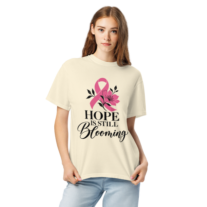 Standing model wearing the ivory “Hope Is Still Blooming” pink-ribbon tee.