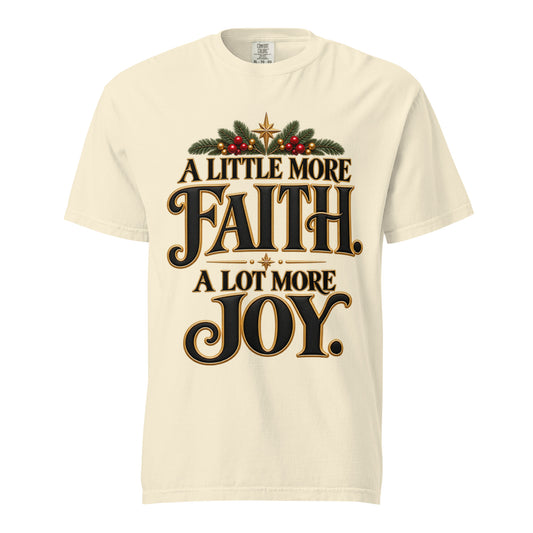  Little More Faith, A Lot More Joy” Christmas tee with black-and-gold lettering, festive greenery, red berries, and gold stars.