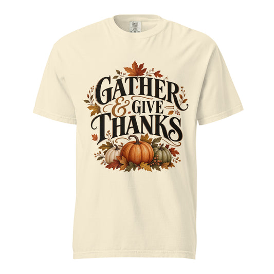 Ivory Comfort Colors tee with "Gather & Give Thanks" lettering, three pumpkins, and autumn leaves on the front.