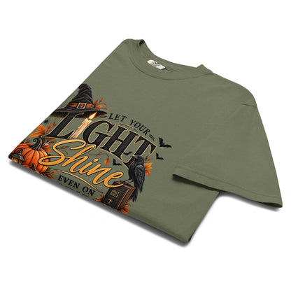 Let Your Light Shine Even on Dark Nights garment-dyed tee in Moss – folded mockup – Matthew 5:16 faith Halloween graphic tee by RavnCo.