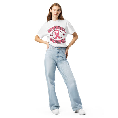 Full-length model wearing the white Her Strength tee with the pink ribbon design.