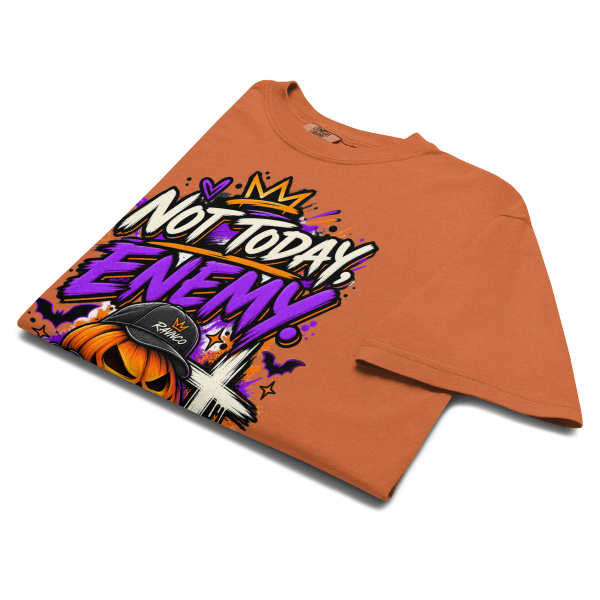 `Not Today, Enemy. garment-dyed tee in Yam – folded flat lay mockup – James 4:7 faith Halloween streetwear graphic tee by RavnCo` Product mockup.