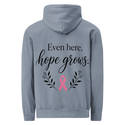 Blue Jean hoodie back with black “Even here, hope grows.” lettering, a pink awareness ribbon, and botanical sprigs