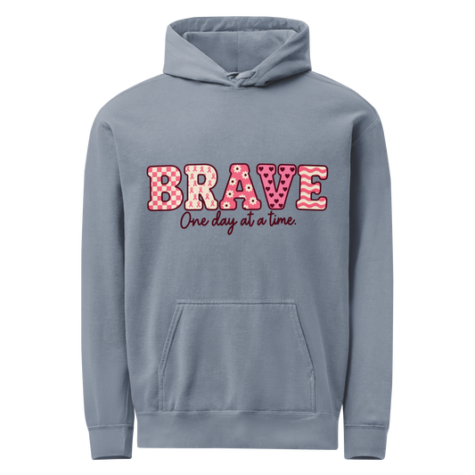 Blue Jean hoodie with pink patterned BRAVE lettering and “One day at a time” on the front