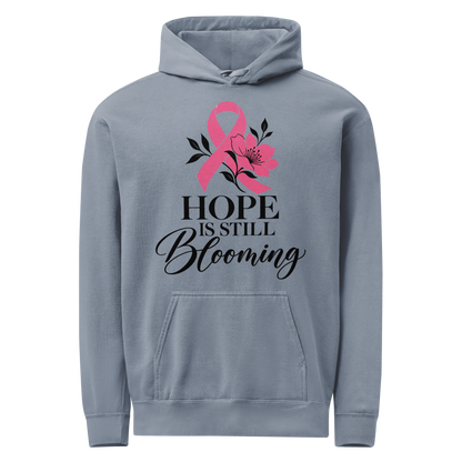 Blue Jean hoodie with black “Hope Is Still Blooming” lettering, a pink awareness ribbon, and floral accents on the front