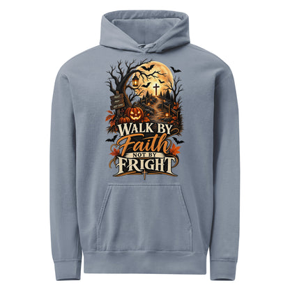Blue Jean hoodie with ‘Walk by Faith Not by Fright’ lettering, a golden moon, pumpkins, lanterns, and a cross along a woodland path.