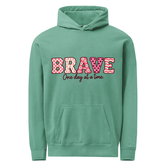 Seafoam hoodie with pink patterned BRAVE lettering and “One day at a time” on the front