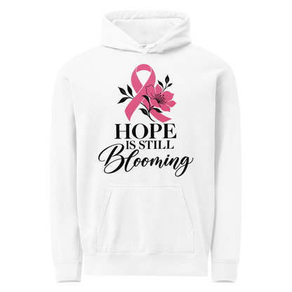 White hoodie with black “Hope Is Still Blooming” lettering, a pink awareness ribbon, and floral accents on the front