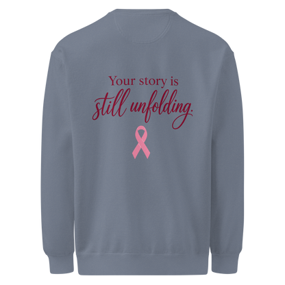 Back of Blue Jean sweatshirt with burgundy “Your story is still unfolding” lettering above a pink breast cancer awareness ribbon.