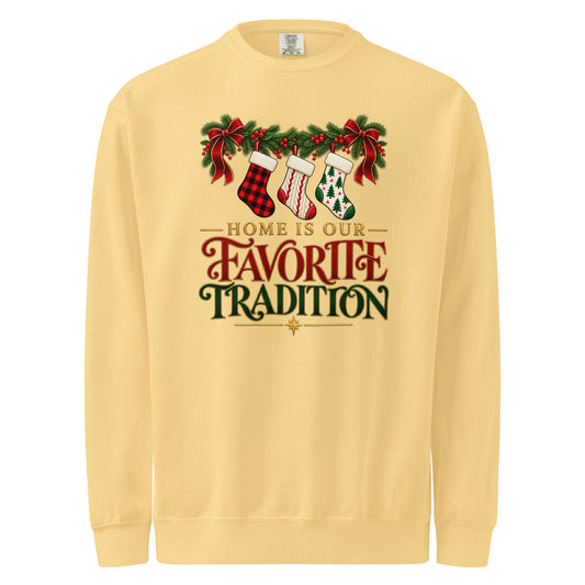 Butter yellow Home Is Our Favorite Tradition sweatshirt with Christmas stockings, red bows, evergreen foliage, and festive lettering.