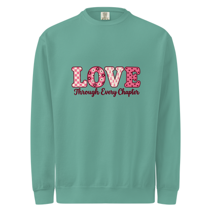 Seafoam sweatshirt with pink patterned LOVE lettering and burgundy “Through Every Chapter” script on the front.