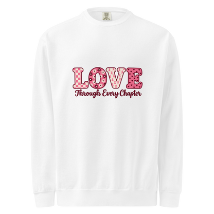 White sweatshirt with pink patterned LOVE lettering and burgundy “Through Every Chapter” script on the front.