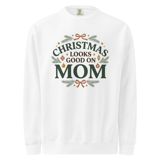 White sweatshirt with “Christmas Looks Good on Mom” lettering, evergreen sprigs, ornaments, and terracotta bows.