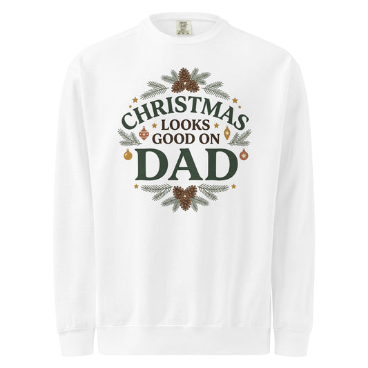 White sweatshirt with “Christmas Looks Good on Dad” lettering, pinecone clusters, evergreen sprigs, and ornaments.